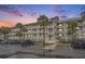 Multi-story building with ample parking and palm trees at 93 Mariners Cay Drive, Folly Beach, SC 29439