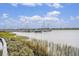 Calm waters and docked boats create a serene marina view at 93 Mariners Cay Drive, Folly Beach, SC 29439