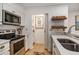 Modern kitchen with stainless steel appliances and white cabinetry at 93 Mariners Cay Drive, Folly Beach, SC 29439