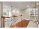 Bright upper hallway with hardwood floors, chandelier, and views to the lower level at 681 Lake Frances Dr, Charleston, SC 29412