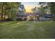 Home's backyard with green grass, patio, and wooded backdrop at 141 Kersey Ter, Goose Creek, SC 29445