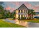 Two-story house with a palm tree, lit up at dusk at 106 Aviary Ct, Summerville, SC 29483