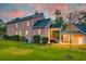 Brick house with a covered patio and well-manicured lawn at 106 Aviary Ct, Summerville, SC 29483