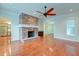 Living room with hardwood floors, brick fireplace, and views of kitchen and dining room at 106 Aviary Ct, Summerville, SC 29483