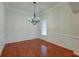 Formal dining room with hardwood floors, chandelier, and wainscoting at 106 Aviary Ct, Summerville, SC 29483