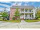 Two-story brick home with a balcony and landscaped yard at 106 Aviary Ct, Summerville, SC 29483