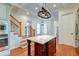 Kitchen island with granite countertop and view of stairs and kitchen cabinets at 106 Aviary Ct, Summerville, SC 29483