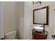 Small updated bathroom with pedestal sink, toilet and ornate mirror at 106 Aviary Ct, Summerville, SC 29483