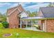 Brick house with attached garage, covered patio, and landscaped yard at 106 Aviary Ct, Summerville, SC 29483