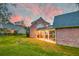 Brick house with covered patio and landscaping, beautiful sunset at 106 Aviary Ct, Summerville, SC 29483