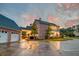Brick home with attached garage and expansive driveway; sunset view at 106 Aviary Ct, Summerville, SC 29483
