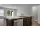 Kitchen island with sink, dishwasher and view into living area at 171 Rosefield Ct, Summerville, SC 29485