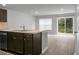 Open kitchen with island, dark brown cabinets and stainless steel appliances at 171 Rosefield Ct, Summerville, SC 29485