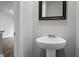 Small bathroom with pedestal sink and framed mirror at 171 Rosefield Ct, Summerville, SC 29485