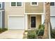 Modern townhouse exterior with a white garage door and black front door at 171 Rosefield Ct, Summerville, SC 29485