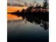 Stunning sunset over calm water with tree silhouettes reflected at 368 Blowing Fresh Dr, Charleston, SC 29492
