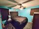 Bedroom with teal walls, ceiling fan, and a black bed at 100 Shamrock Dr, Summerville, SC 29483