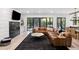Living room features a fireplace, large TV, and sliding glass doors to backyard at 4028 Gnarled Oaks Ln, Johns Island, SC 29455