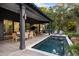 Covered deck with pool, outdoor seating and wooded views at 4028 Gnarled Oaks Ln, Johns Island, SC 29455