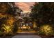 Home exterior at night with landscape lighting at 4028 Gnarled Oaks Ln, Johns Island, SC 29455