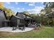 A patio with firepit and seating area in a large backyard with a pool and deck at 4028 Gnarled Oaks Ln, Johns Island, SC 29455