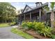 Home exterior featuring a welcoming front porch and meticulously landscaped grounds at 4028 Gnarled Oaks Ln, Johns Island, SC 29455