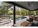 View from covered porch, showcasing pool and lush greenery at 4028 Gnarled Oaks Ln, Johns Island, SC 29455