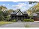 A beautiful two-story house with a large porch and nicely landscaped front yard at 4028 Gnarled Oaks Ln, Johns Island, SC 29455