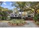 House exterior showcasing a two-story home with a wraparound porch and attached garage at 4028 Gnarled Oaks Ln, Johns Island, SC 29455