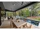 Outdoor dining area on deck next to a refreshing pool at 4028 Gnarled Oaks Ln, Johns Island, SC 29455