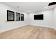 Spacious media room with hardwood floors and a large TV at 4028 Gnarled Oaks Ln, Johns Island, SC 29455
