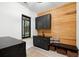 Laundry room with dark cabinetry, wood-paneled walls, and a built-in bench at 4028 Gnarled Oaks Ln, Johns Island, SC 29455