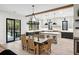 Modern kitchen with dark cabinetry, island, and dining area at 4028 Gnarled Oaks Ln, Johns Island, SC 29455