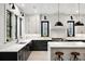 Modern kitchen with marble countertops, black cabinets, and gold hardware at 4028 Gnarled Oaks Ln, Johns Island, SC 29455