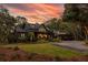 Two-story home with modern farmhouse exterior, charming porch and landscaping at 4028 Gnarled Oaks Ln, Johns Island, SC 29455