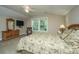 Bright bedroom with a king-size bed, dresser, and a ceiling fan at 220 Brutus Ln, Summerville, SC 29485