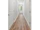 Bright hallway with wood-look floors and doors leading to other rooms at 186 E Pinckney St, Lincolnville, SC 29485