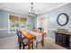 Bright dining room features a wood table, four chairs, and a view to the backyard at 1802 Wood Duck Rd, Moncks Corner, SC 29461