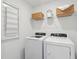 Clean laundry room with washer, dryer, and storage shelves at 8783 Silver Perch Ln, North Charleston, SC 29420