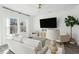 Relaxing living room with large windows and hardwood floors at 8783 Silver Perch Ln, North Charleston, SC 29420