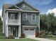 Two-story craftsman style home with a detached garage and manicured landscaping at 341 Chapman Cir, Goose Creek, SC 29445