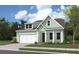Single-story home with a light green exterior, white trim, and a two-car garage at 510 Eagleview Dr, Moncks Corner, SC 29461