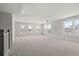Large loft bedroom with carpet, multiple windows, and access to balcony at 501 Eagle View Dr, Moncks Corner, SC 29461