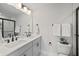 Double vanity bathroom with gray cabinets and a frameless shower at 345 Bremerton Dr, Goose Creek, SC 29445