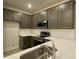Modern kitchen with dark gray cabinets, white countertops, and stainless steel appliances at 345 Bremerton Dr, Goose Creek, SC 29445