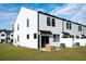 Rear view of townhouses, showing patio and fenced backyard at 345 Bremerton Dr, Goose Creek, SC 29445