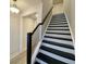 Modern staircase with black railing and white risers leading to the second floor at 345 Bremerton Dr, Goose Creek, SC 29445