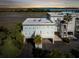 Evening aerial view of three-story townhouse with water views at 1665 A Marsh Harbor Ln, Mount Pleasant, SC 29464