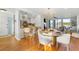Open concept dining area with kitchen and living room visible, hardwood floors at 1665 A Marsh Harbor Ln, Mount Pleasant, SC 29464