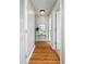 Hallway with hardwood floors and console table at 1665 A Marsh Harbor Ln, Mount Pleasant, SC 29464